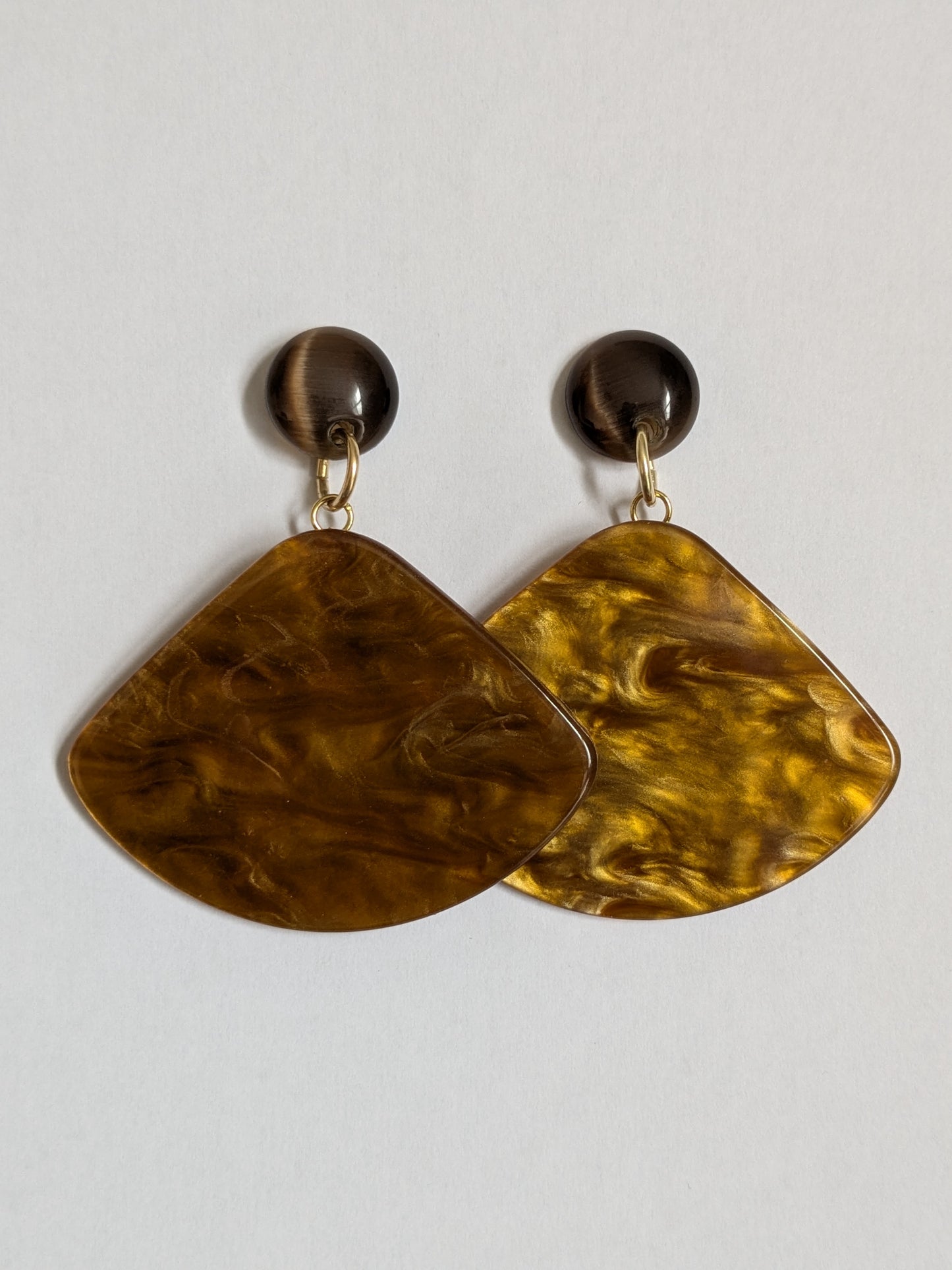 Bold statement earrings made with brown vintage plastic studs and marbled effect mustard yellow triangular dangles, with new gold plated earring posts.