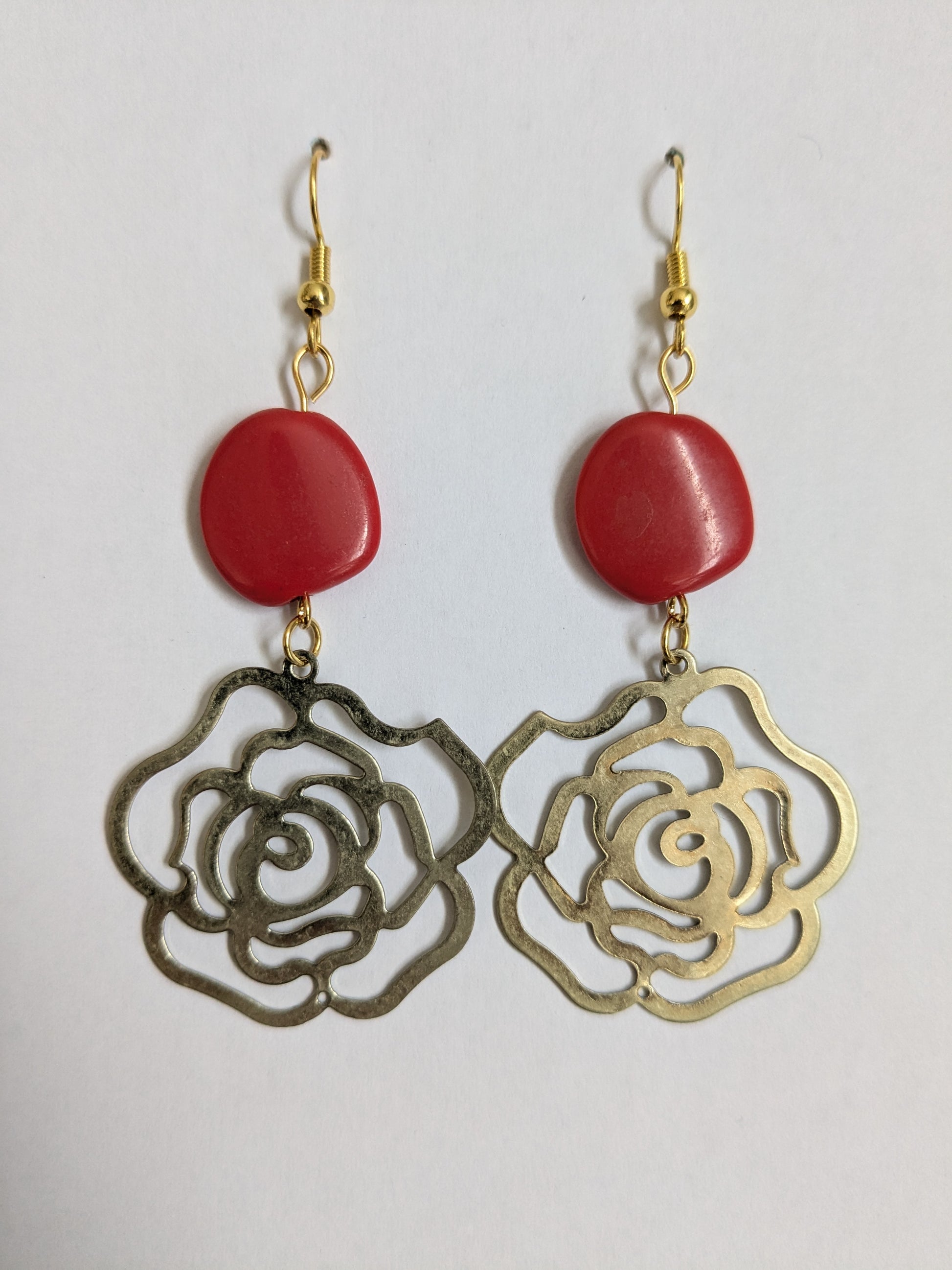 Dangle earrings made with vintage brass rose charms, red beads, with new gold-plated wires.